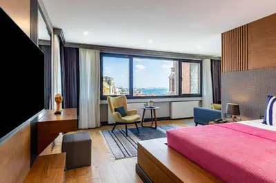 a bedroom with a bed and a large window at SALA SUITES in Istanbul