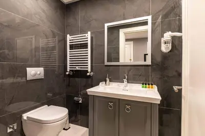 a bathroom with a toilet and a sink and a mirror at SALA SUITES in Istanbul