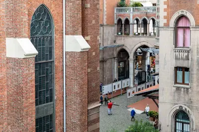 a group of people walking in a courtyard between two buildings at SALA SUITES in Istanbul