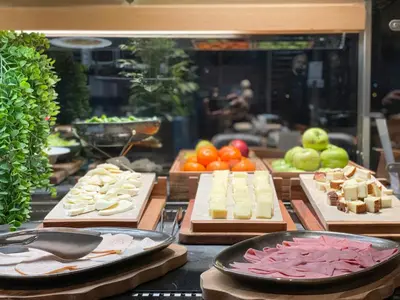 a buffet with cheese and other foods on display at Four Points by Sheraton Istanbul Kagithane in Istanbul