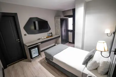 a hotel room with a bed and a tv at Express Plus Hotel in Istanbul