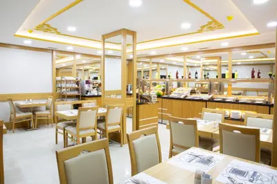a restaurant with tables and chairs and a counter at Alpinn Hotel DUE in Istanbul