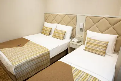 a hotel room with two beds in a room at Alpinn Hotel DUE in Istanbul