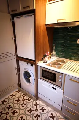 a kitchen with a stove and a washing machine at Superior refurbished flat in the heart of Istanbul in Istanbul