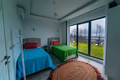 a bedroom with two beds and a large window at Sapanca villa in Sapanca