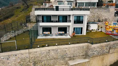 a house on top of a retaining wall with a house at Sapanca villa in Sapanca