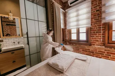 a woman standing in a kitchen washing towels at Galadoo Suites 2nd Floor in Istanbul