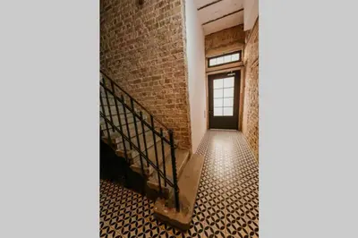 a staircase in an old brick building with a window at Galadoo Suites 4th Floor in Istanbul