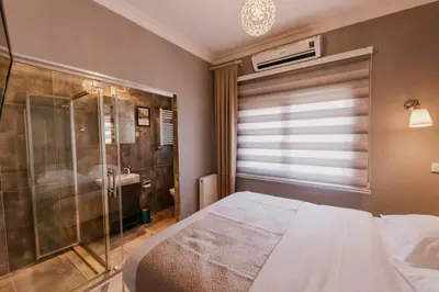 a bedroom with a bed and a glass shower at Galadoo Suites 4th Floor in Istanbul