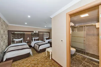 a hotel room with two beds and a bathroom at Montagna Hera Hotel Taksim in Istanbul
