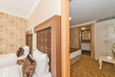 a hotel room with a bed and a bathroom at Montagna Hera Hotel Taksim in Istanbul