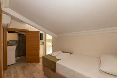 a small bedroom with a bed and a bathroom at Bazaar Hotels Old City in Istanbul