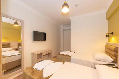 a hotel room with two beds and a mirror at Bazaar Hotels Old City in Istanbul