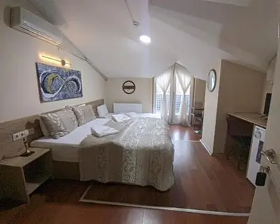 a bedroom with a large bed in a room at Rumeli Konak Butik Otel in Tekirdag
