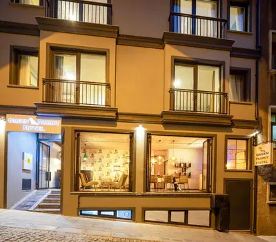 a building with large windows with furniture in it at Green Parrot Hotel Istanbul in Istanbul