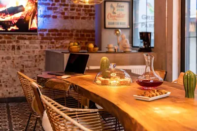 a wooden table with a laptop on top of it at Green Parrot Hotel Istanbul in Istanbul
