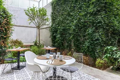 a patio with two tables and chairs on a courtyard at Green Parrot Hotel Istanbul in Istanbul
