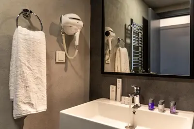 a bathroom with a white sink and a mirror at Green Parrot Hotel Istanbul in Istanbul