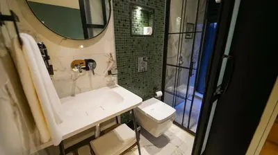 a bathroom with a sink and a toilet and a mirror at Fragments Hotel in Istanbul