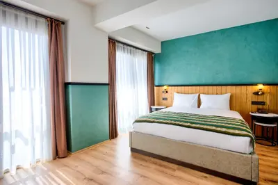 a bedroom with a bed and a green wall at Fragments Hotel in Istanbul