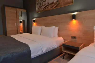 a hotel room with two beds and a table at MİLLS HOTEL in Tekirdag