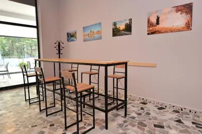 a table and chairs in a room with paintings on the wall at MİLLS HOTEL in Tekirdag