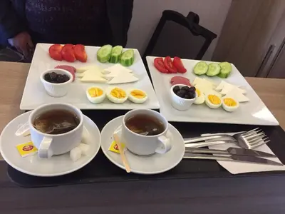 a tray with two cups of coffee and appetizers at Okda Hotel in Istanbul