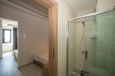 a bathroom with a shower and a glass shower stall at Okda Hotel in Istanbul