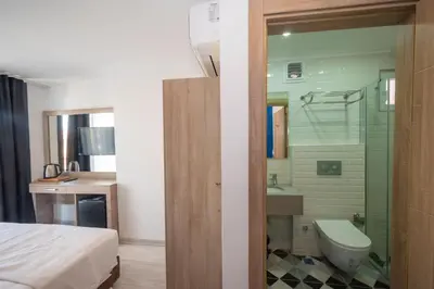 a bathroom with a shower and a toilet and a sink at Okda Hotel in Istanbul