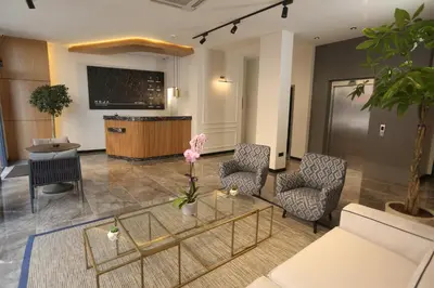 a lobby with chairs and a table and a bar at Moja City Hotel in Istanbul
