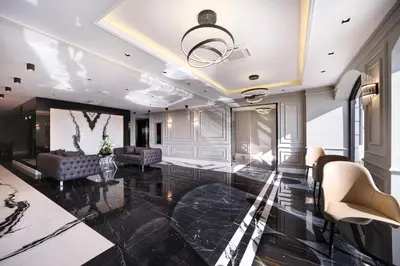 a living room with a black marble floor at Dora Pera Hotel in Istanbul