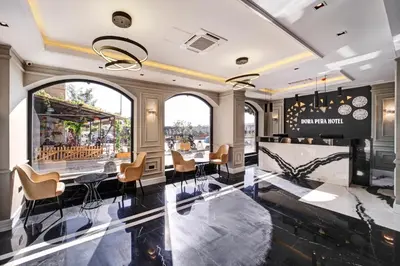 a restaurant with a bar with chairs and tables at Dora Pera Hotel in Istanbul