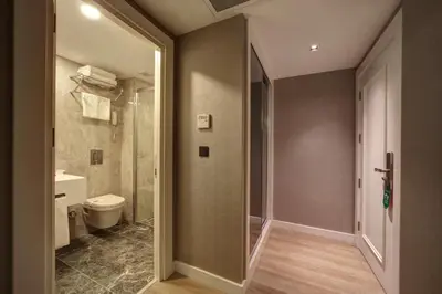a bathroom with a toilet and a walk in shower at Dora Pera Hotel in Istanbul