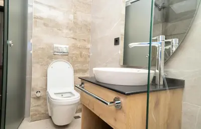 a bathroom with a toilet and a sink and a mirror at Fama Karaköy in Istanbul