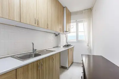 a kitchen with wooden cabinets and a sink at Altiyol Boga, Center of Kadıköy in Istanbul