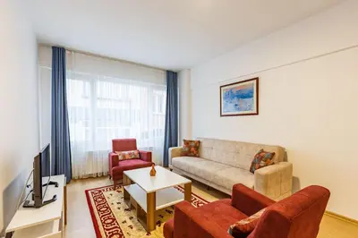 a living room with a couch and chairs and a tv at Altiyol Boga, Center of Kadıköy in Istanbul