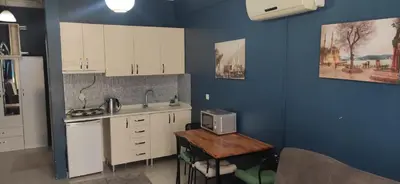 a kitchen with white cabinets and a counter with a microwave at Laluna Hotel Near Grand Bazaar City Center in Istanbul