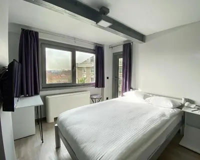 a bedroom with a white bed and a window at Eresin Hotels Express in Istanbul