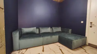 a living room with a couch against a purple wall at Mas Suites Karaköy in Istanbul