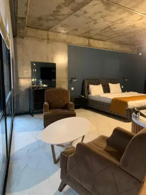 a bedroom with a bed and a table and chairs at Mas Suites Karaköy in Istanbul