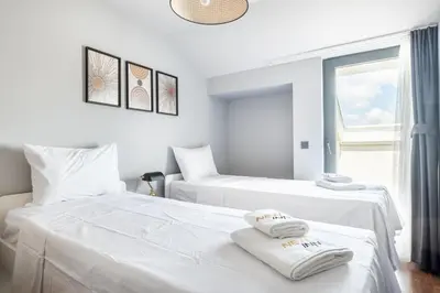 two beds in a hotel room with towels on them at Benesta Residence by NewInn in Istanbul