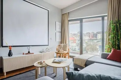 a living room with a couch and a large window at Benesta Residence by NewInn in Istanbul