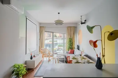 a living room with a couch and a table at Benesta Residence by NewInn in Istanbul