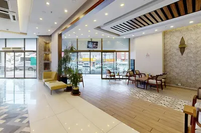 a lobby of a restaurant with a table and chairs at King City Hotel Istanbul Ataturk Airport in Istanbul