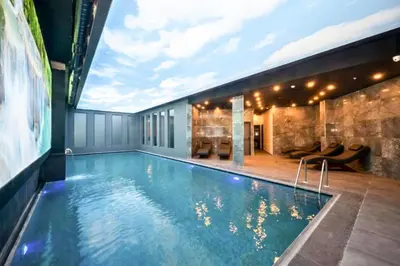 a swimming pool in the middle of a building at King City Hotel Istanbul Ataturk Airport in Istanbul