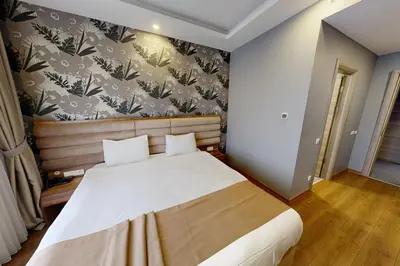 a bedroom with a large bed with a floral wallpaper at King City Hotel Istanbul Ataturk Airport in Istanbul