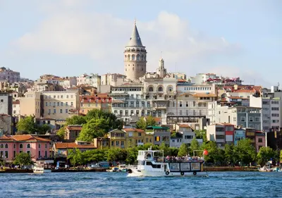 a boat in the water in front of a city at Istanbul Old City Topkapi Porta Romanos Hotel Ottoman Heritage in Istanbul