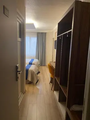 a hotel room with a bed and a room with a door at ERA PALACE HOTEL B BLOK in Istanbul