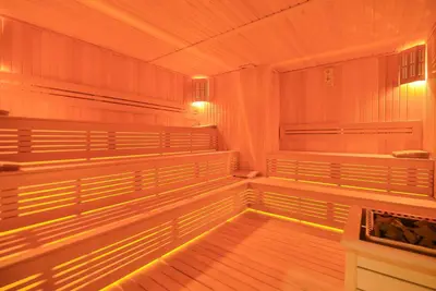 an empty sauna with wood floors and lights at SERENİTY COMFORT Hotel in Istanbul
