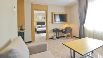 a hotel room with a bed and a living room at SERENİTY COMFORT Hotel in Istanbul